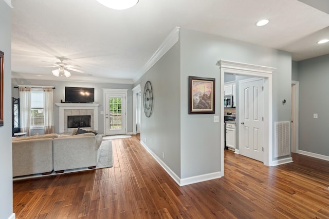 102 Munson Ct, Smyrna, TN 37167 - unfurnished living room featuring ceiling fan, dark wood finished floors, baseboards, ornamental molding, and a fireplace