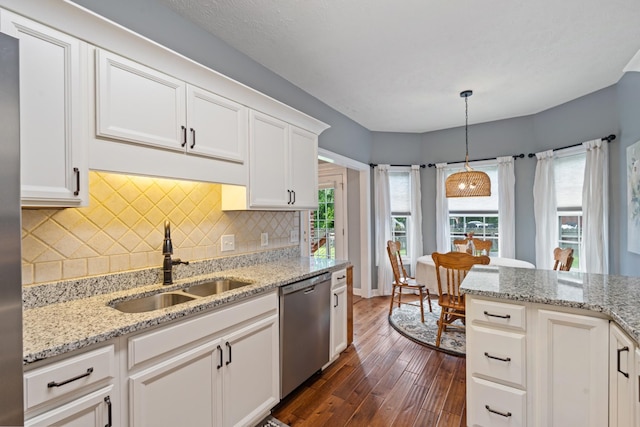 102 Munson Ct, Smyrna, TN 37167 - kitchen with stainless steel dishwasher, a sink, dark wood-type flooring, decorative backsplash, and white cabinetry