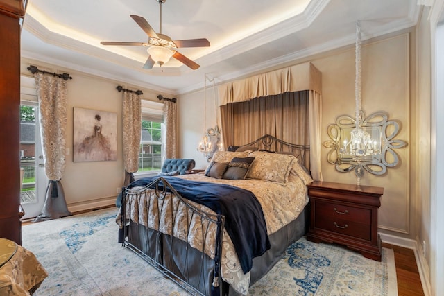 102 Munson Ct, Smyrna, TN 37167 - bedroom with ornamental molding, a raised ceiling, a chandelier, light wood-style flooring, and a ceiling fan