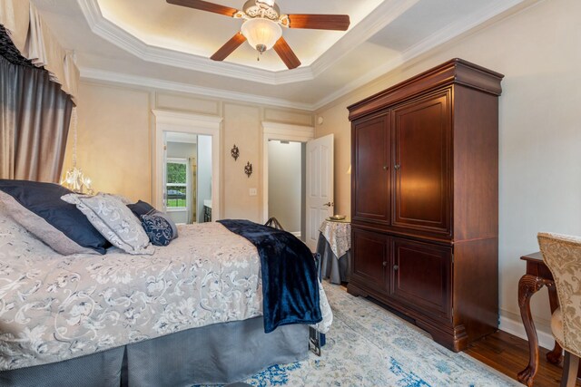 102 Munson Ct, Smyrna, TN 37167 - bedroom with crown molding, light wood-style flooring, a ceiling fan, and a raised ceiling