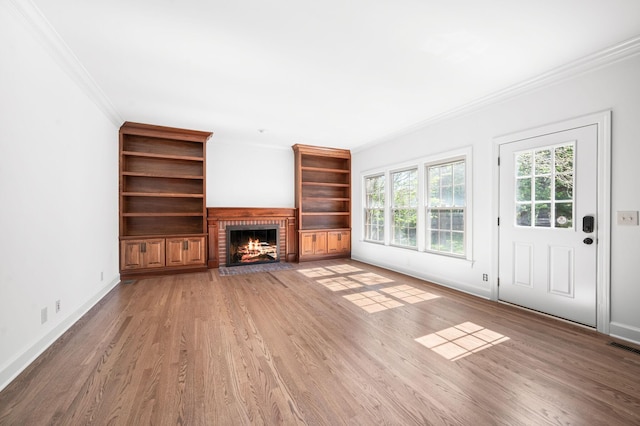 1008 Green Hill Cv, Brentwood, TN 37027 - unfurnished living room featuring crown molding, light wood finished floors, a fireplace, baseboards, and visible vents