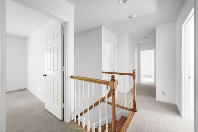 1008 Green Hill Cv, Brentwood, TN 37027 - hallway featuring carpet floors, baseboards, and an upstairs landing