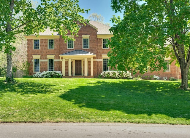1008 Green Hill Cv, Brentwood, TN 37027 - georgian-style home featuring a standing seam roof, brick siding, a front yard, and metal roof