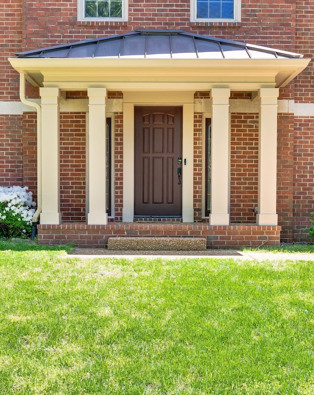 1008 Green Hill Cv, Brentwood, TN 37027 - view of exterior entry with brick siding and a lawn