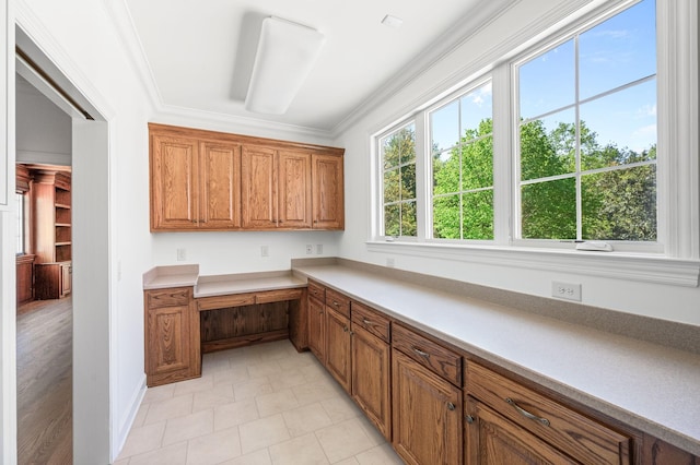 1008 Green Hill Cv, Brentwood, TN 37027 - interior space featuring light countertops, brown cabinetry, crown molding, and built in desk