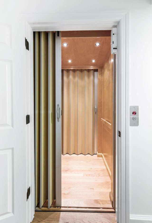 1008 Green Hill Cv, Brentwood, TN 37027 - hall featuring elevator, wood finished floors, and recessed lighting