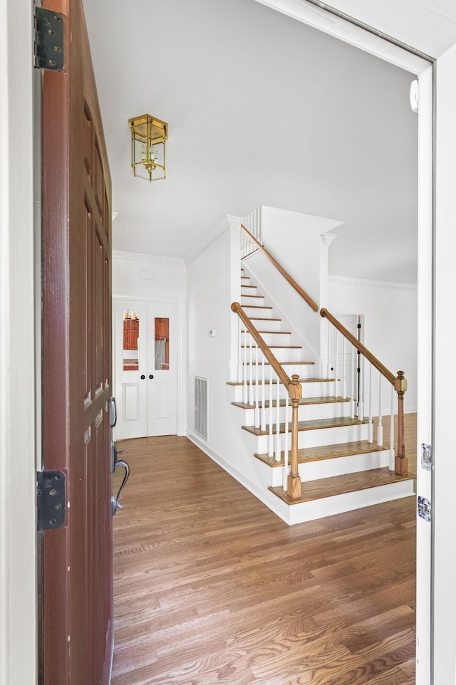 1008 Green Hill Cv, Brentwood, TN 37027 - entrance foyer featuring stairway, crown molding, wood finished floors, and visible vents