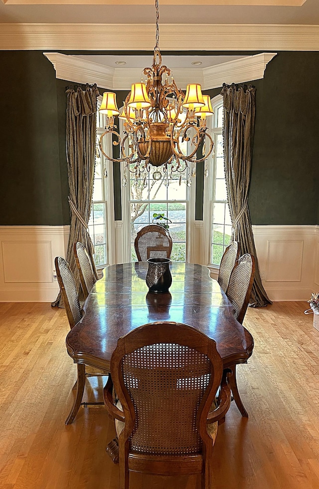 247 Woods Ferry Cir, Gallatin, TN 37066 - dining room featuring a chandelier, wood finished floors, a wainscoted wall, crown molding, and a decorative wall