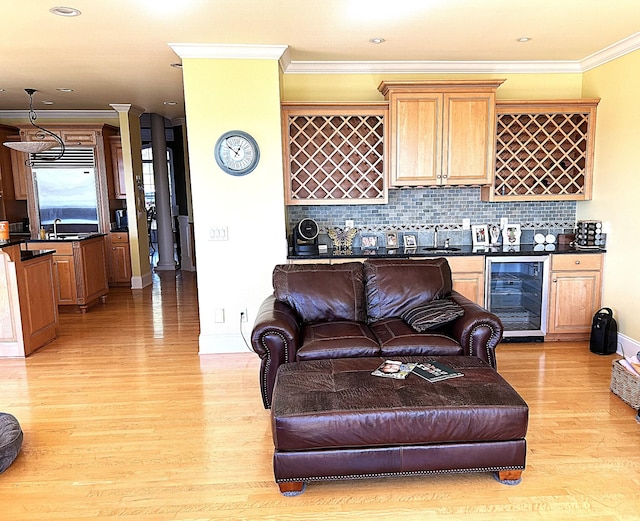 247 Woods Ferry Cir, Gallatin, TN 37066 - living area with wine cooler, light wood-style floors, ornamental molding, baseboards, and ornate columns