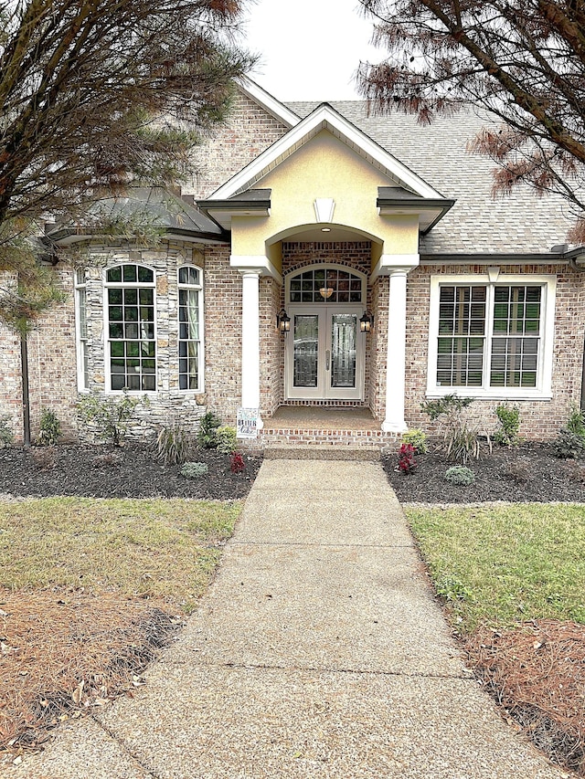 247 Woods Ferry Cir, Gallatin, TN 37066 - view of exterior entry with french doors, a shingled roof, and stone siding