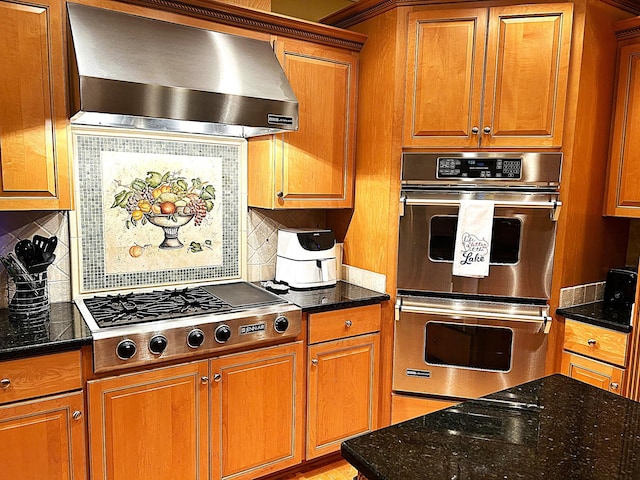 247 Woods Ferry Cir, Gallatin, TN 37066 - kitchen with stainless steel appliances, wall chimney exhaust hood, brown cabinetry, and dark stone countertops