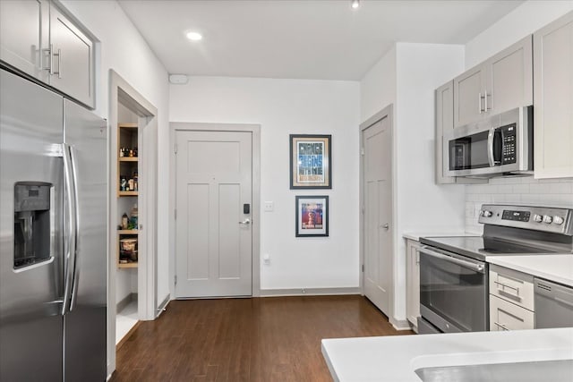 1638 54th Ave N Unit 320, Nashville, TN 37209 - kitchen with appliances with stainless steel finishes, tasteful backsplash, dark wood-type flooring, and light countertops