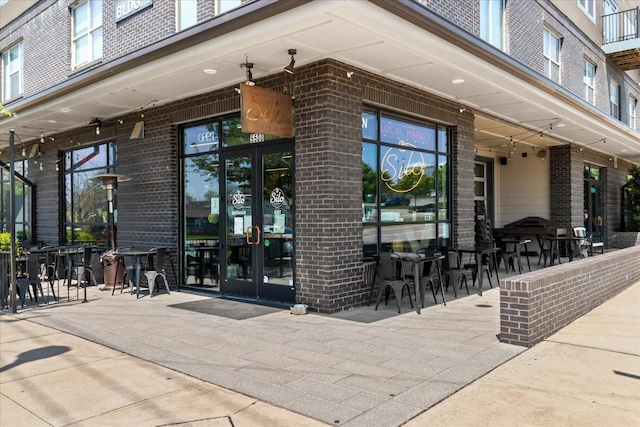 1638 54th Ave N Unit 320, Nashville, TN 37209 - view of exterior entry with brick siding, french doors, and outdoor dining area