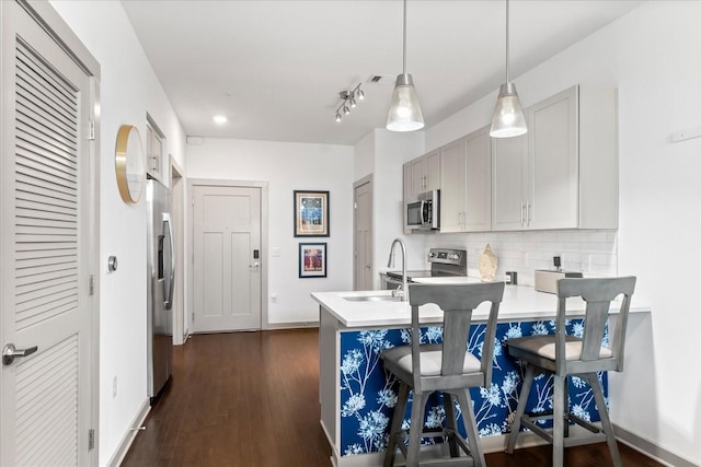 1638 54th Ave N Unit 320, Nashville, TN 37209 - kitchen featuring a breakfast bar area, stainless steel appliances, light countertops, backsplash, and a peninsula