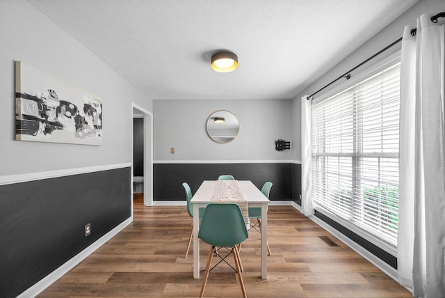 3051 Outfitters Dr, Clarksville, TN 37040 - dining area featuring wood finished floors, a healthy amount of sunlight, and visible vents