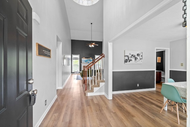 3051 Outfitters Dr, Clarksville, TN 37040 - entryway featuring a ceiling fan, stairs, wood finished floors, a towering ceiling, and baseboards
