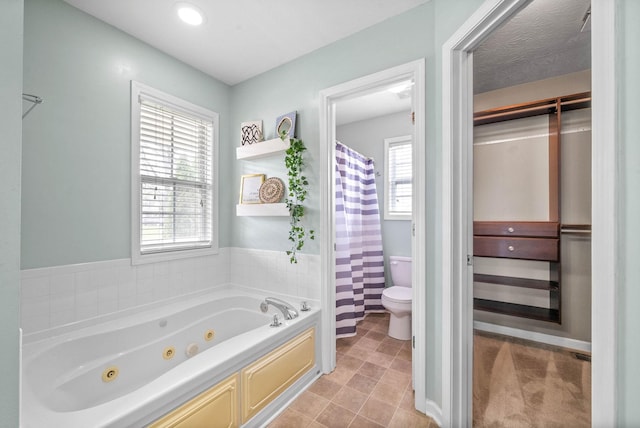 3051 Outfitters Dr, Clarksville, TN 37040 - bathroom featuring toilet, a shower with shower curtain, and a jetted tub