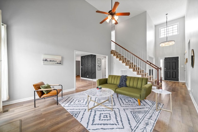3051 Outfitters Dr, Clarksville, TN 37040 - living area featuring baseboards, wood finished floors, a high ceiling, and stairs