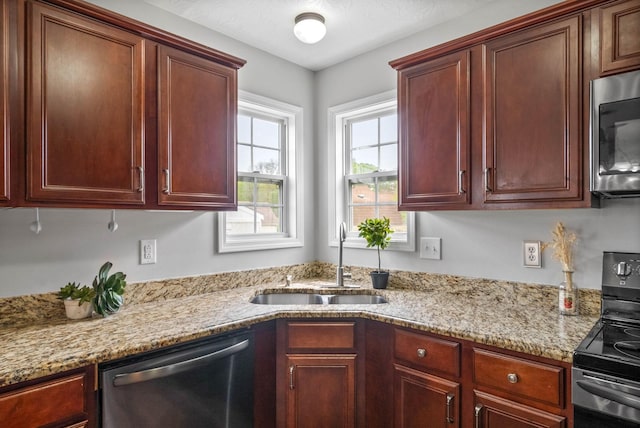 3051 Outfitters Dr, Clarksville, TN 37040 - kitchen with light stone counters, appliances with stainless steel finishes, and a sink