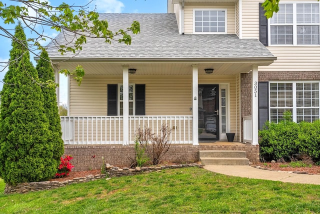 3051 Outfitters Dr, Clarksville, TN 37040 - property entrance featuring roof with shingles, a porch, and a lawn