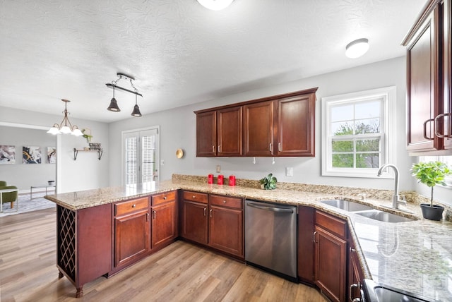 3051 Outfitters Dr, Clarksville, TN 37040 - kitchen featuring a peninsula, light wood-style floors, stainless steel dishwasher, and a sink