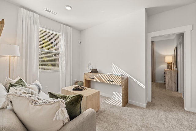sitting room featuring visible vents, carpet flooring, and baseboards