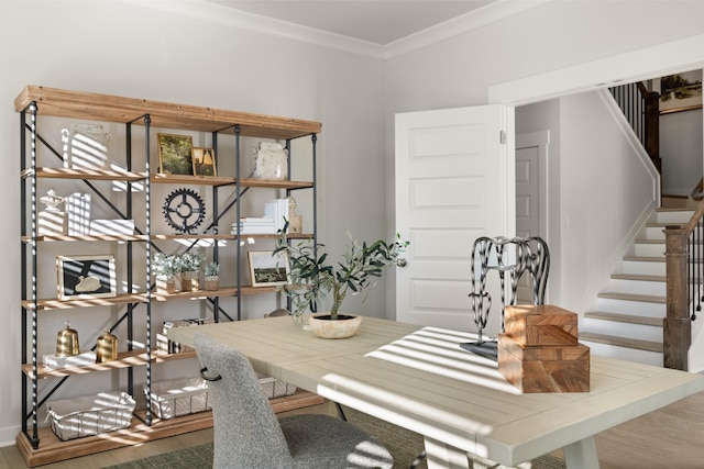 dining room featuring stairway, baseboards, wood finished floors, and ornamental molding