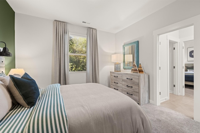 bedroom featuring light carpet, baseboards, and visible vents