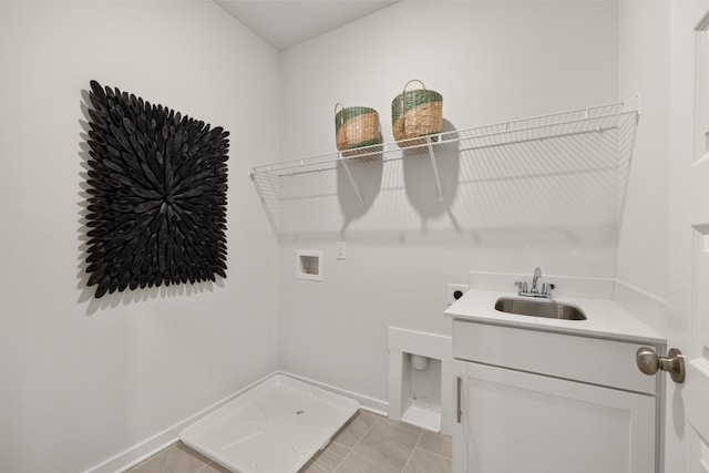 laundry room with light tile patterned floors, a sink, hookup for a washing machine, baseboards, and electric dryer hookup
