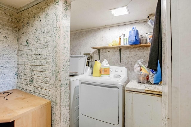 clothes washing area featuring separate washer and dryer