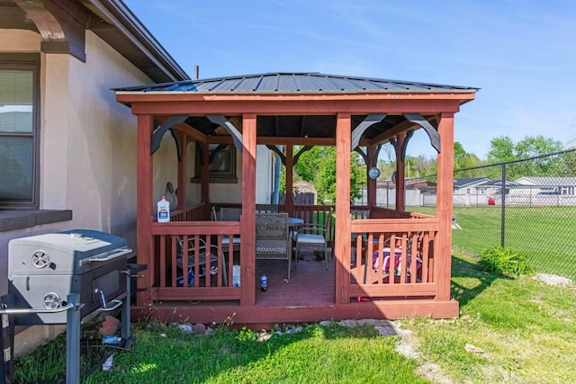 wooden deck with fence, a gazebo, a yard, and area for grilling