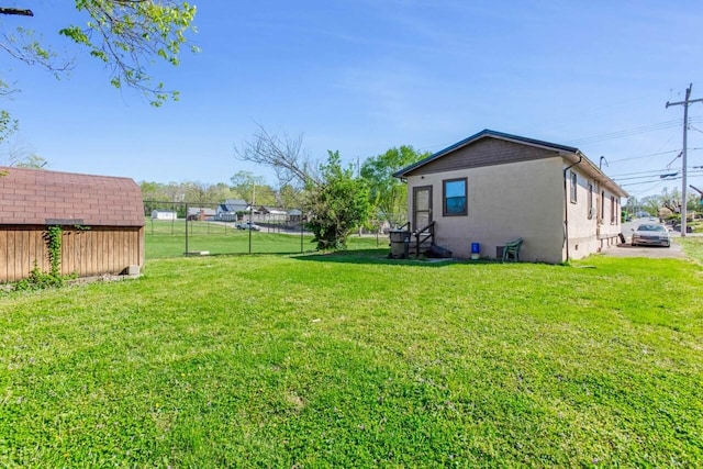 view of yard with an outdoor structure and fence