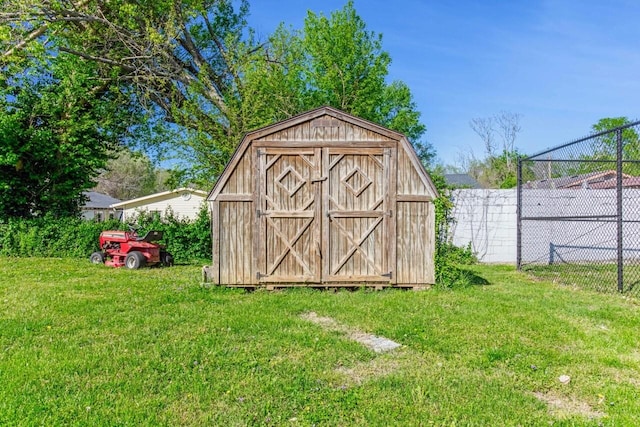 view of shed featuring fence