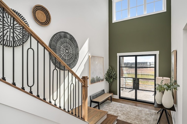 interior space with wood finished floors and a high ceiling