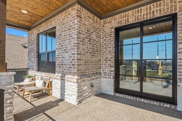 entrance to property with brick siding and french doors