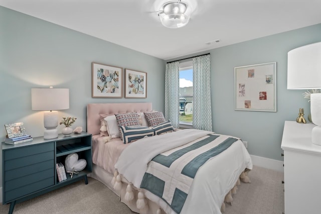 bedroom featuring baseboards, visible vents, and carpet