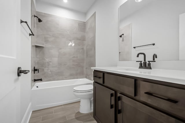 full bathroom with toilet, vanity, and shower / tub combination