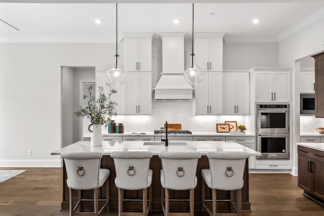 kitchen featuring custom exhaust hood, crown molding, light countertops, backsplash, and appliances with stainless steel finishes
