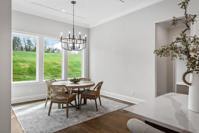 dining space with baseboards, a notable chandelier, and dark wood-type flooring