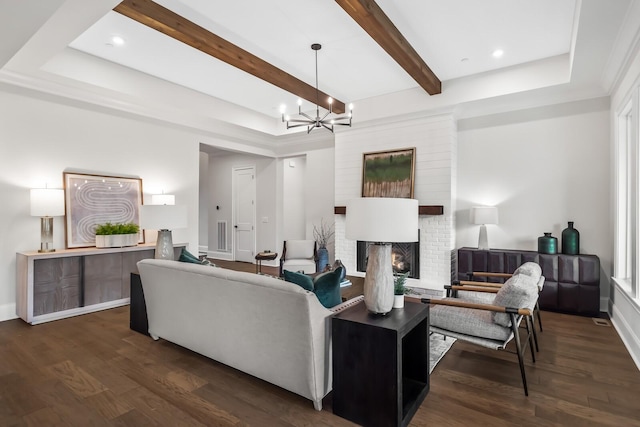 living room with a fireplace, a notable chandelier, wood finished floors, and beam ceiling