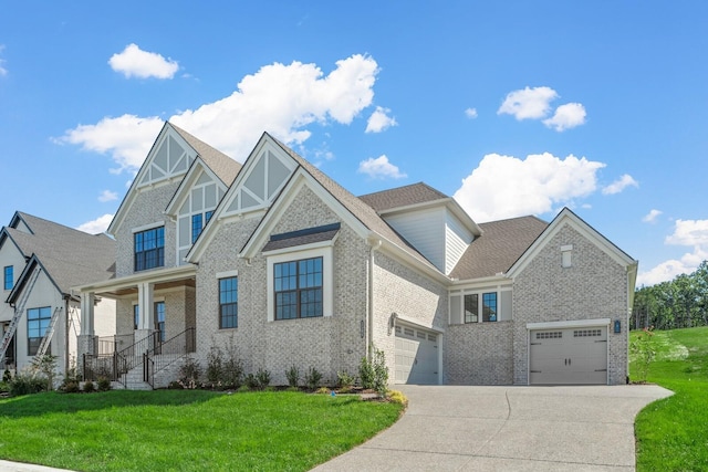 view of front of home featuring roof with shingles, a front lawn, driveway, brick siding, and an attached garage