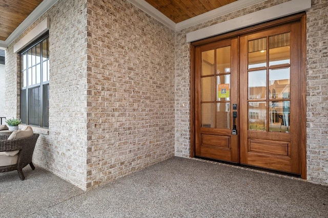 entrance to property featuring brick siding and french doors