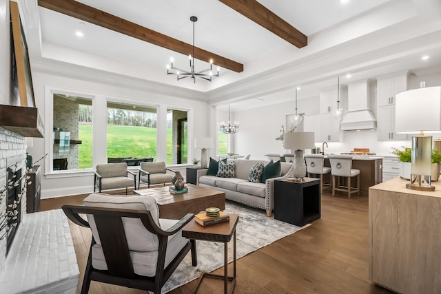 living room featuring recessed lighting, beam ceiling, dark wood-style flooring, and an inviting chandelier