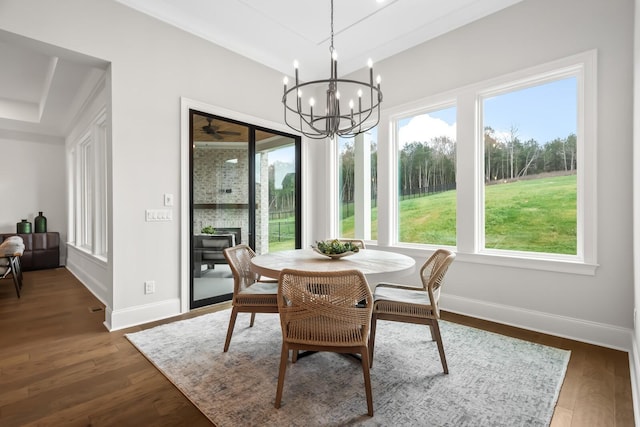 dining area featuring baseboards, dark wood-style flooring, and an inviting chandelier