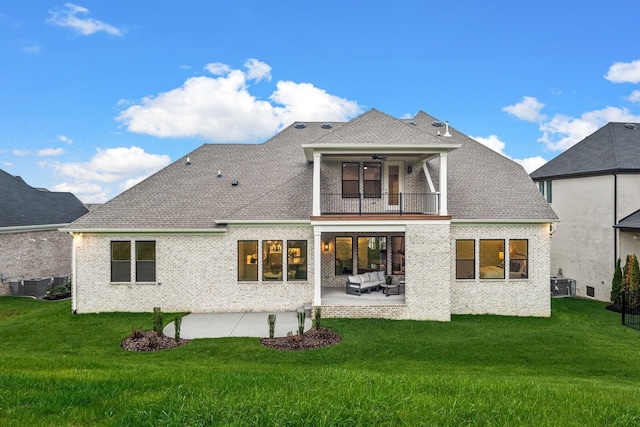 back of house featuring an outdoor living space, a balcony, central air condition unit, a patio, and ceiling fan