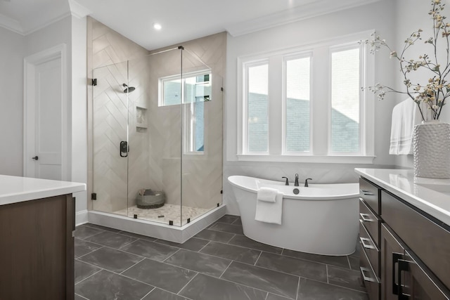 bathroom featuring recessed lighting, vanity, crown molding, a soaking tub, and a stall shower