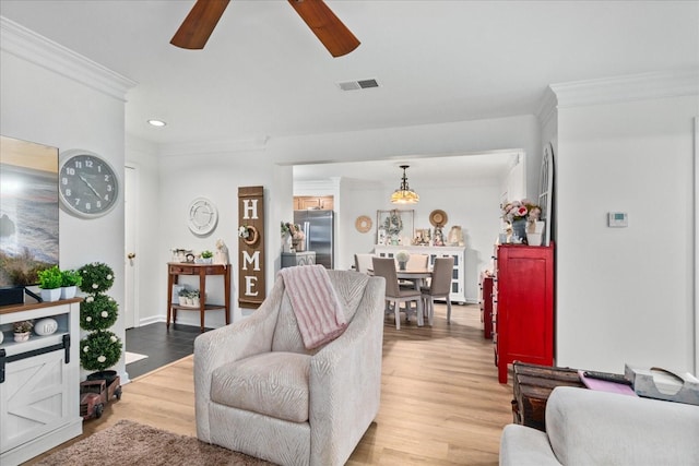 470 S Main St Unit 106, Ashland City, TN 37015 - living area featuring light wood-type flooring, visible vents, a ceiling fan, and ornamental molding