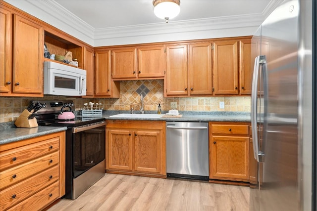 470 S Main St Unit 106, Ashland City, TN 37015 - kitchen featuring light wood finished floors, appliances with stainless steel finishes, decorative backsplash, and a sink