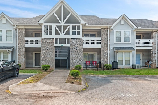 470 S Main St Unit 106, Ashland City, TN 37015 - townhome / multi-family property with uncovered parking, central AC unit, and roof with shingles
