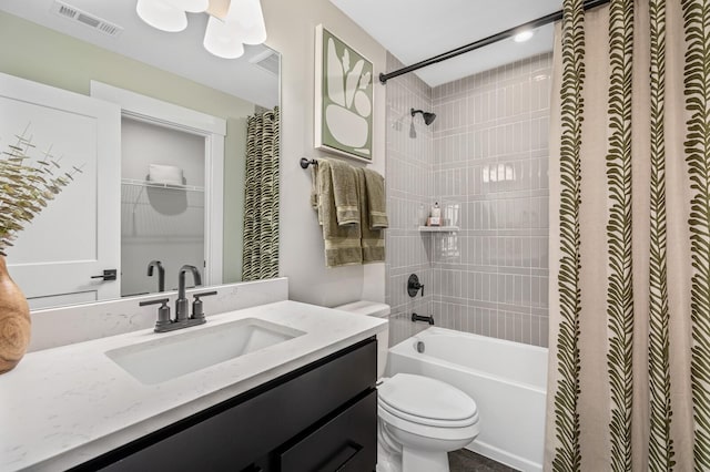 full bath featuring toilet, shower / bath combo with shower curtain, vanity, and visible vents